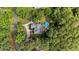 Areal view of a luxurious property featuring mature trees and private pool oasis at 308 Thomas Dr, Clayton, NC 27520