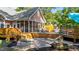 A backyard featuring a spacious patio, multi-level deck, lounging area, and screened-in porch for outdoor living at 308 Thomas Dr, Clayton, NC 27520