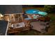 Aerial view of a backyard featuring a pool, deck, patio, and comfortable outdoor seating arrangements at 308 Thomas Dr, Clayton, NC 27520