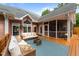 Back exterior of house features outdoor furniture, and an outdoor screened in porch at 308 Thomas Dr, Clayton, NC 27520