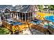 A backyard showcasing a multi-level deck, screened-in porch, lounging area, and well-maintained landscaping at 308 Thomas Dr, Clayton, NC 27520