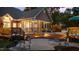 Back exterior of house features outdoor furniture, and an outdoor screened in porch at dusk at 308 Thomas Dr, Clayton, NC 27520