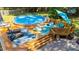 A backyard paradise featuring an above-ground pool, spacious deck, patio, and comfortable outdoor seating at 308 Thomas Dr, Clayton, NC 27520