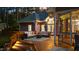 A wooden deck featuring outdoor seating, elegant lighting, and access to a screened-in porch for relaxation at 308 Thomas Dr, Clayton, NC 27520