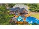 An aerial view of the home's backyard, with an above-ground pool, spacious patio, and comfortable seating arrangements at 308 Thomas Dr, Clayton, NC 27520