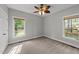 Empty bedroom with neutral carpet, two windows and a ceiling fan at 308 Thomas Dr, Clayton, NC 27520