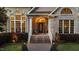 Inviting brick home entrance with arched windows and charming front porch details at 308 Thomas Dr, Clayton, NC 27520