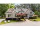 Charming brick home featuring a landscaped front yard, circular driveway, and classic architectural details at 308 Thomas Dr, Clayton, NC 27520