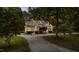 A brick house showcasing its well-maintained front lawn, elegant landscaping, and inviting circular driveway at 308 Thomas Dr, Clayton, NC 27520