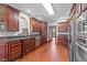 Large kitchen with granite countertops, wood cabinets, stainless steel appliances and wood floors at 308 Thomas Dr, Clayton, NC 27520