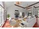 Bright living room with fireplace, white furniture, ceiling fans, and hardwood floors at 308 Thomas Dr, Clayton, NC 27520