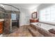 Luxurious bathroom featuring step up tub, glass enclosed shower and custom window at 308 Thomas Dr, Clayton, NC 27520
