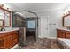 Nicely appointed bathroom with glass shower, dual vanities, and tile flooring at 308 Thomas Dr, Clayton, NC 27520