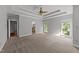Bright and airy main bedroom featuring large windows and neutral carpeting at 308 Thomas Dr, Clayton, NC 27520