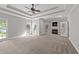 Spacious main bedroom with large windows, fireplace, and tray ceiling with fan at 308 Thomas Dr, Clayton, NC 27520