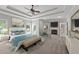 Bright main bedroom with ceiling fan, fireplace, sitting area, and large bed at 308 Thomas Dr, Clayton, NC 27520