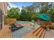 Spacious pool deck with lounge chairs, an above ground pool, and an umbrella at 308 Thomas Dr, Clayton, NC 27520