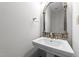 Elegant powder room featuring a decorative mirror and pedestal sink at 308 Thomas Dr, Clayton, NC 27520