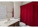 Bathroom with vanity, sink, toilet, and red shower curtain at 309 Coachman'S Trl, Stem, NC 27581