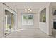 Open dining room with a chandelier, sliding glass door, and view into the living room at 309 Coachman'S Trl, Stem, NC 27581
