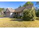 Charming one-story home with a two-car garage, stone accents, and manicured landscaping at 309 Coachman'S Trl, Stem, NC 27581