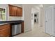 Galley kitchen showcasing stainless steel dishwasher, dark countertops and light colored floors at 309 Coachman'S Trl, Stem, NC 27581