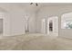 Spacious living room with a vaulted ceiling, multiple doorways, and lots of natural light at 309 Coachman'S Trl, Stem, NC 27581