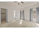 Spacious main bedroom with neutral walls, carpet, ceiling fan, and bright windows at 309 Coachman'S Trl, Stem, NC 27581