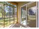 View of screened porch showing screened windows and sliding glass door at 309 Coachman'S Trl, Stem, NC 27581