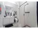 Well-lit bathroom with modern vanity and tiled shower, and door to toilet at 319 Fayetteville St, Raleigh, NC 27601