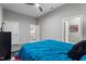 Bedroom with polished concrete floor, ceiling fan and view to en suite bathroom at 319 Fayetteville St, Raleigh, NC 27601