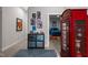 Hallway featuring modern artwork and a red telephone booth leading to a bedroom at 319 Fayetteville St, Raleigh, NC 27601