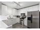 Well-lit kitchen featuring stainless steel appliances, white cabinetry, and a modern backsplash at 319 Fayetteville St, Raleigh, NC 27601