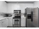 Close-up view of a well-equipped kitchen with stainless steel appliances and stylish white cabinetry at 319 Fayetteville St, Raleigh, NC 27601