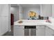 Partial view of a modern kitchen with white countertops and cabinetry, and stainless steel appliances at 319 Fayetteville St, Raleigh, NC 27601