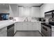 Contemporary kitchen with stainless steel appliances, white cabinetry, and ample counter space at 319 Fayetteville St, Raleigh, NC 27601