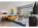 Bright living room features high ceilings, large windows, stylish decor, and a comfortable sectional sofa at 319 Fayetteville St, Raleigh, NC 27601
