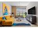 Bright living room features high ceilings, large windows, stylish decor, and a comfortable sectional sofa at 319 Fayetteville St, Raleigh, NC 27601