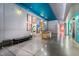 Modern lobby features colorful art, concierge desk, elevators, and sleek, polished concrete floors at 319 Fayetteville St, Raleigh, NC 27601
