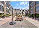 Spacious patio area with seating, tables, and community barbecue grills at 319 Fayetteville St, Raleigh, NC 27601