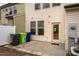 Backyard patio area of a townhome with an access door and trash receptacles at 3623 Landshire View Ln, Raleigh, NC 27616