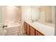 Bathroom showing tub-shower combo with vanity and mirror at 3623 Landshire View Ln, Raleigh, NC 27616