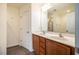 Bathroom features double sink vanity, framed mirror, walk-in shower, and wood-look floor at 3623 Landshire View Ln, Raleigh, NC 27616