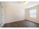 Bedroom features wood-look floors, and one window with white blinds at 3623 Landshire View Ln, Raleigh, NC 27616