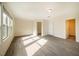 Spacious bedroom showcasing gray wood-look floors, two windows, and two entry doors at 3623 Landshire View Ln, Raleigh, NC 27616