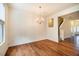 Dining room features laminate flooring, a chandelier, and lots of natural light from the nearby window at 3623 Landshire View Ln, Raleigh, NC 27616