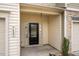 Covered front entrance featuring a black front door with sidelights and house number at 3623 Landshire View Ln, Raleigh, NC 27616