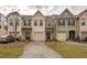A row of beautifully designed townhomes with individual garages, driveways, and manicured lawns at 3623 Landshire View Ln, Raleigh, NC 27616