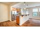 Modern kitchen area with stainless steel appliances, granite countertops, and wood floors at 3623 Landshire View Ln, Raleigh, NC 27616
