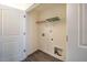 The laundry room features a storage shelf, utility connections, and white trim at 3623 Landshire View Ln, Raleigh, NC 27616